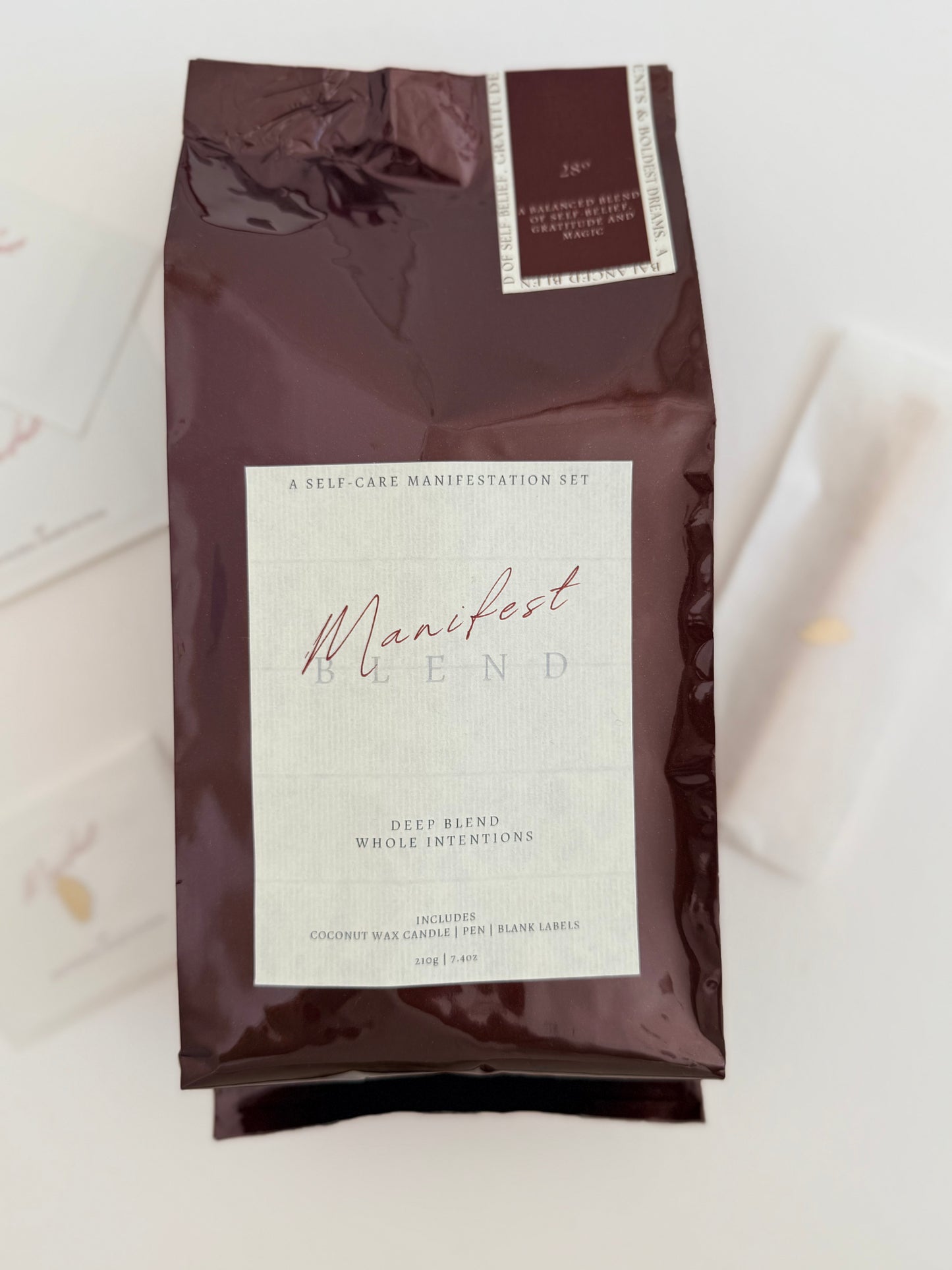 Coffee bag labeled 'Manifest Blend' on a light background