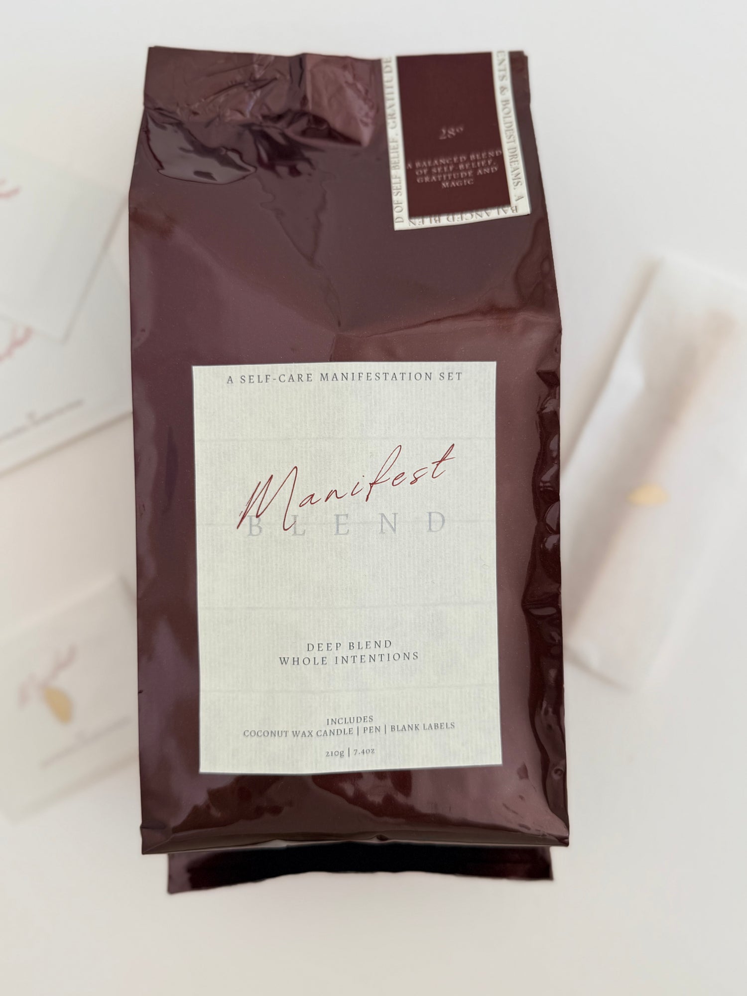 Coffee bag labeled 'Manifest Blend' on a light background