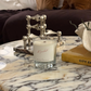 Candle on a marble table with decorative items