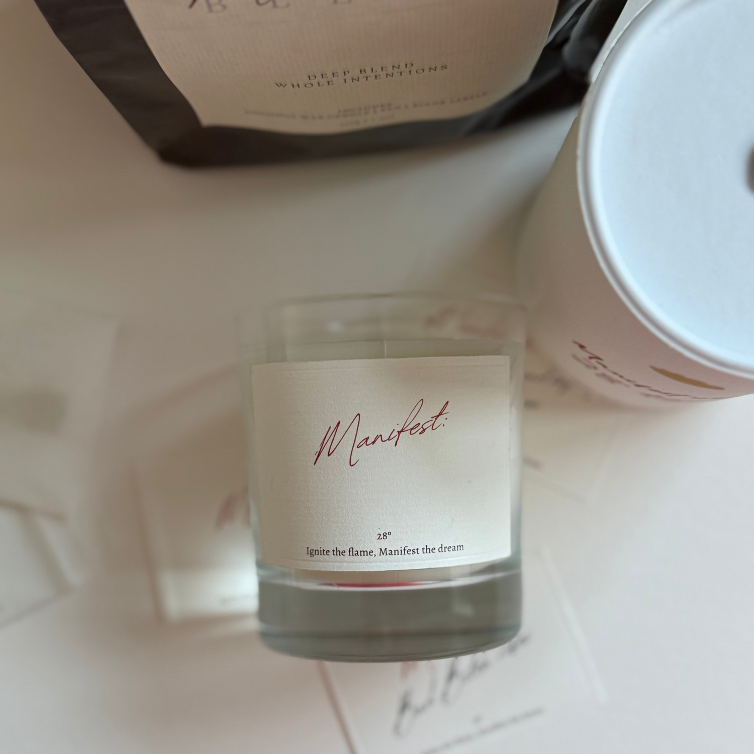 manifest Candle with a label on a light surface
